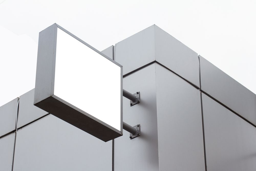 Blank Rectangular Sign Attached to a Light Gray Building — Truecraft Services in Biboohra, QLD