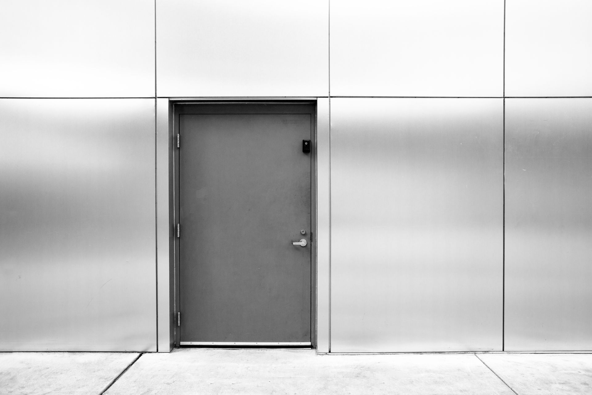 close grey door with aluminum or steel wall. close grey door with aluminum or steel wall.