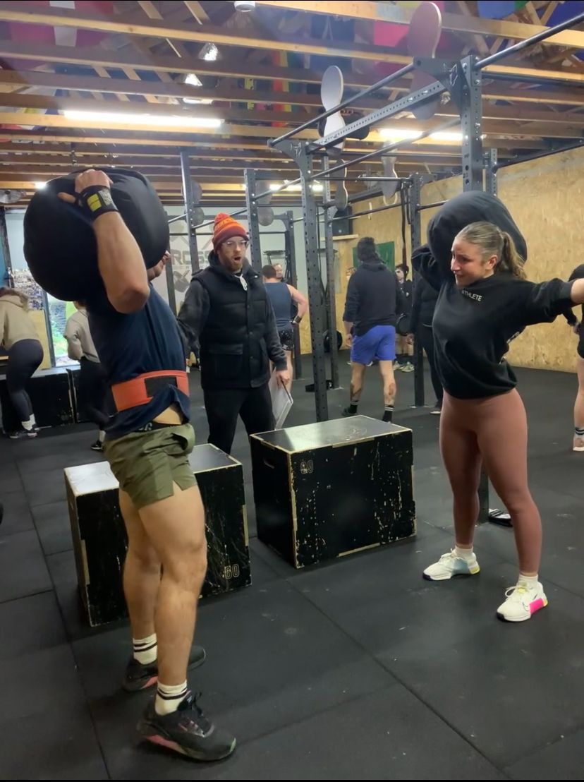A group of people are doing exercises in a gym.
