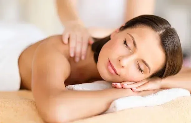 Woman receiving a soothing back massage at home.