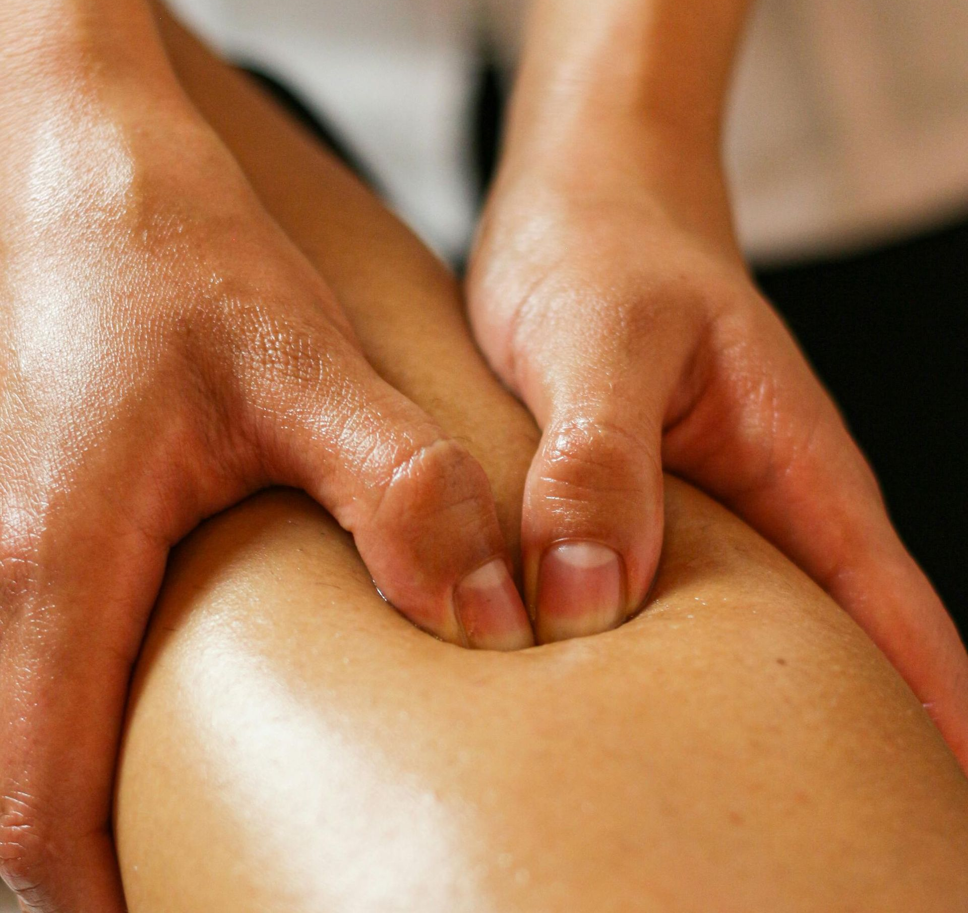 Close-up of hands performing trigger point therapy.