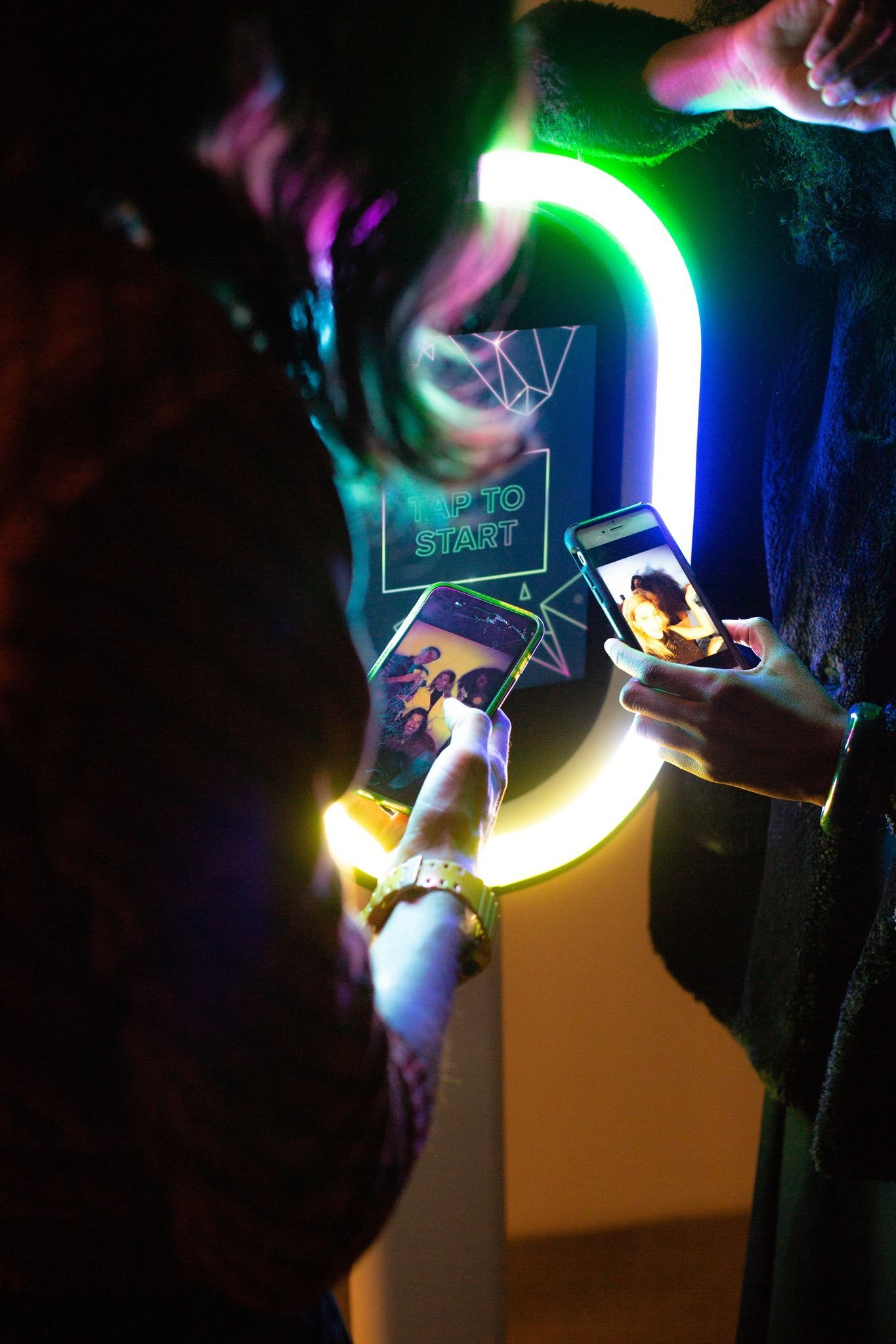 A woman is taking a picture of herself in a photo booth.