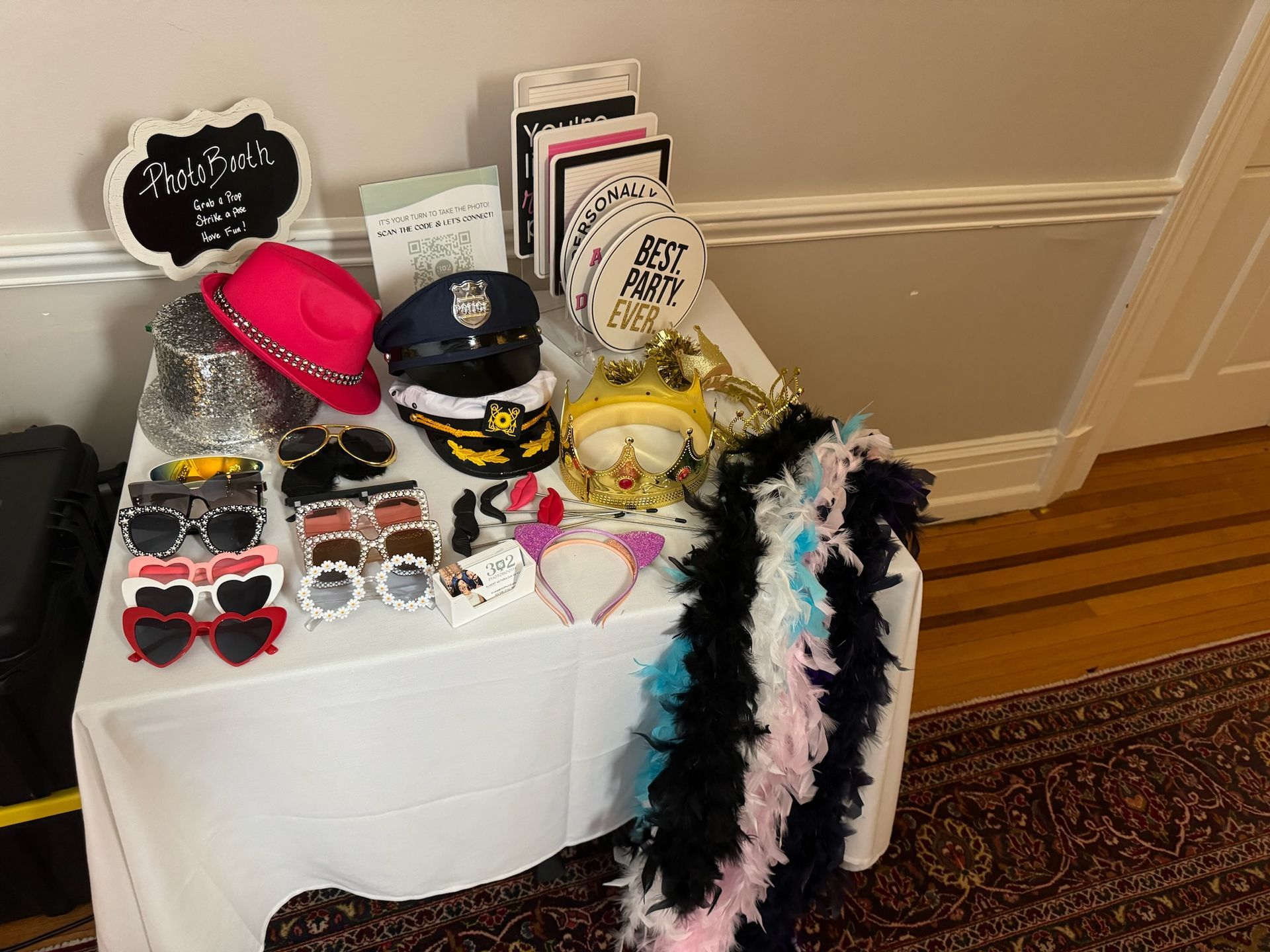 A table topped with a variety of photo booth props.