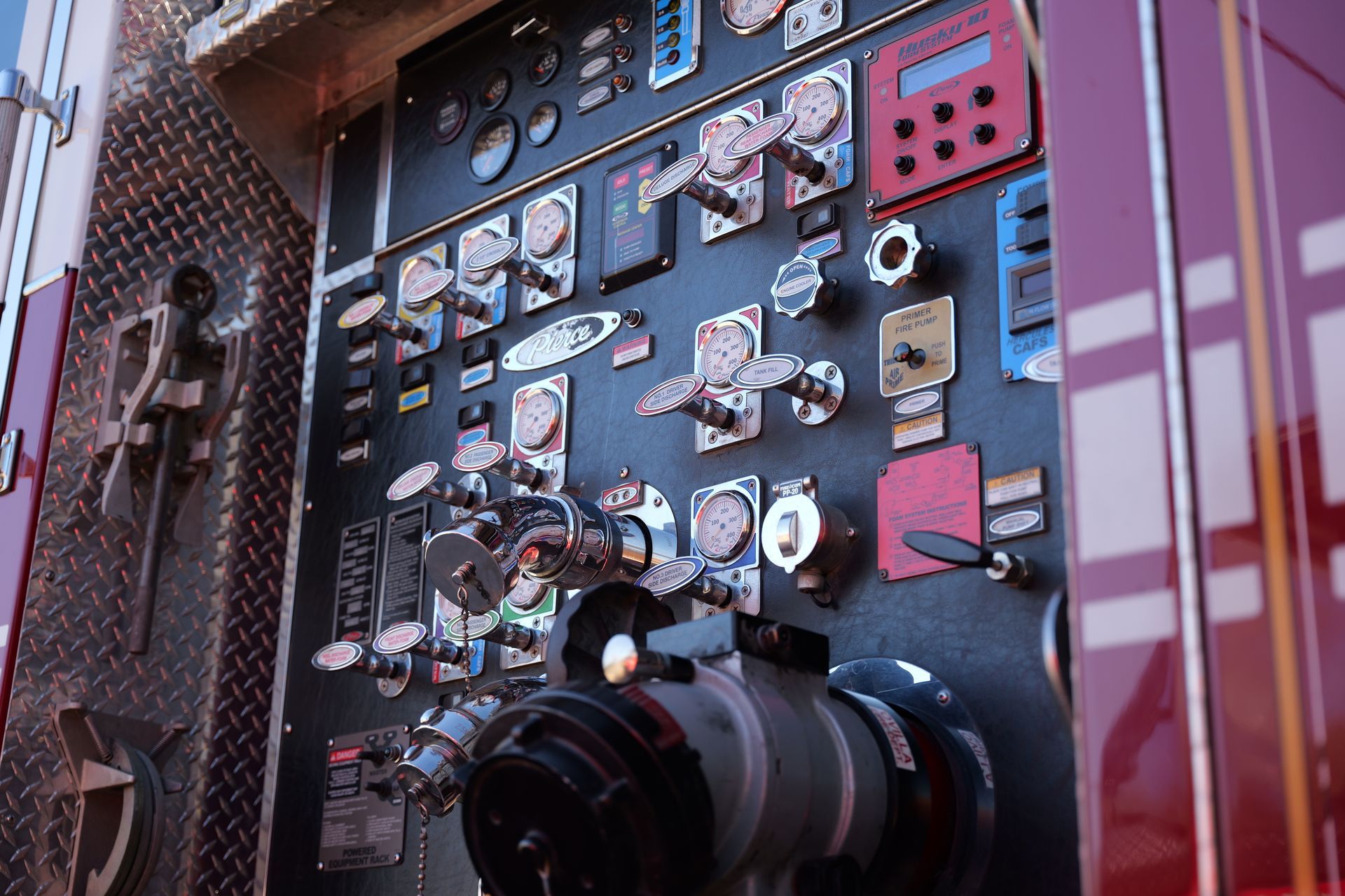 A picture of a pump panel on the side of a fire truck