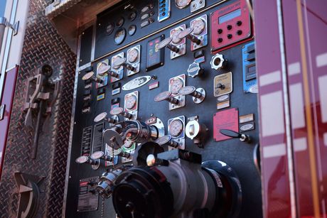 A picture of a pump panel on the side of a fire truck