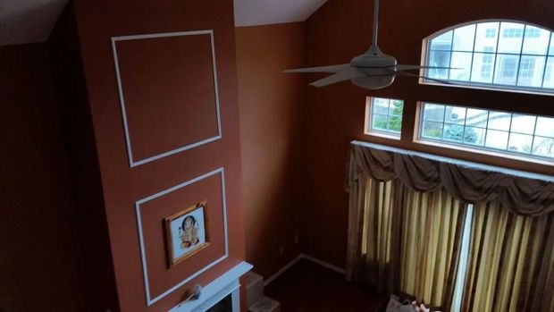 High-angle view of a room with a tall, reddish-brown wall.