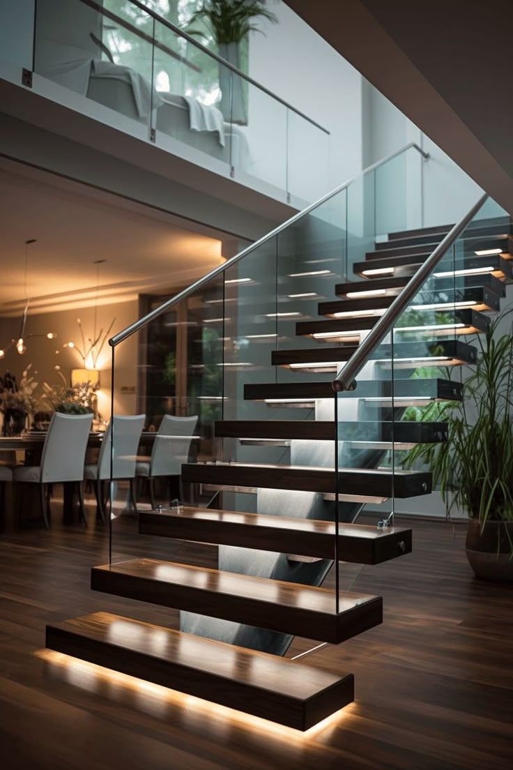 Modern interior with floating wooden staircase, glass railing, and warm floor lighting