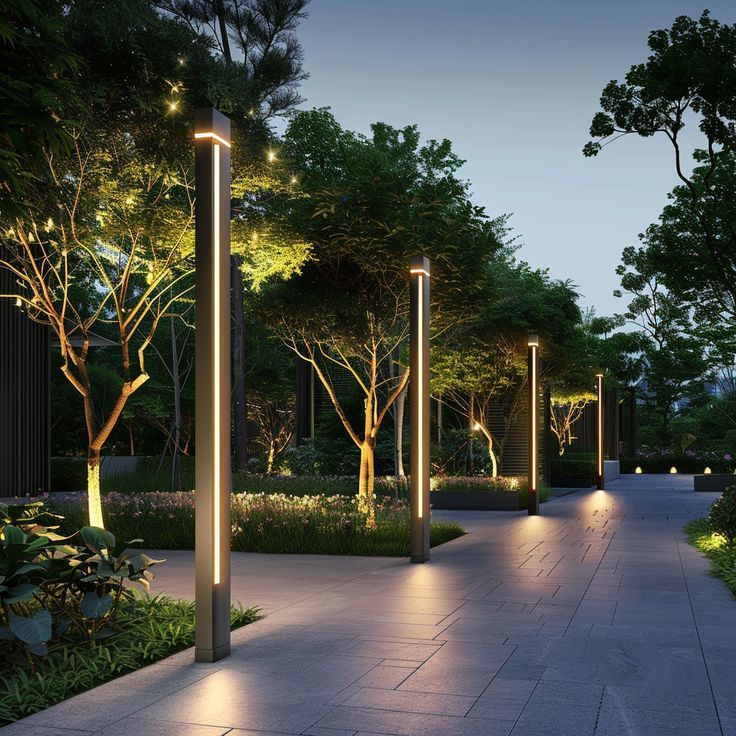 Modern lit walkway with sleek lamp posts, trees, and paved path at dusk