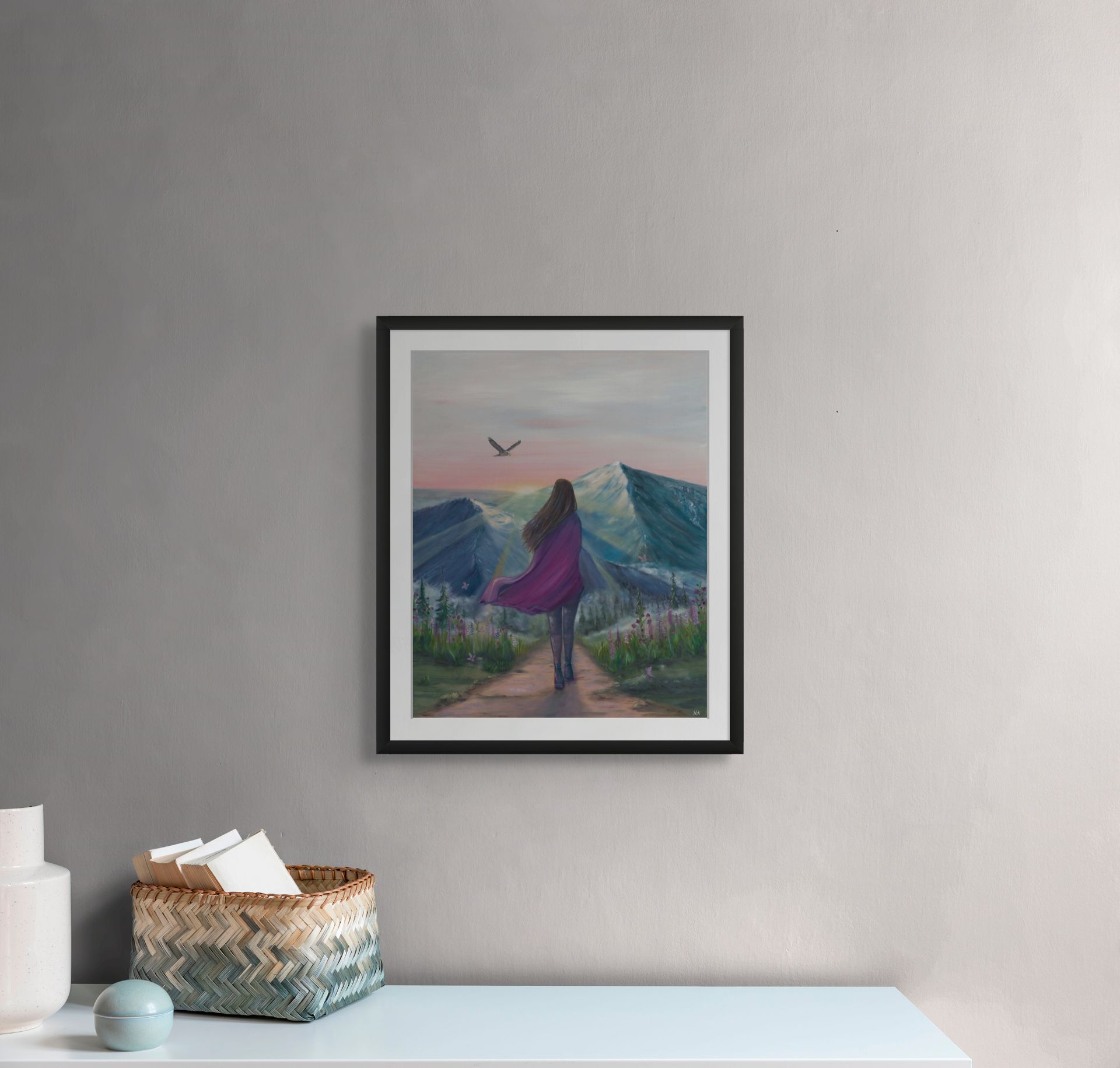 A painting of a woman is hanging on a wall above a table.