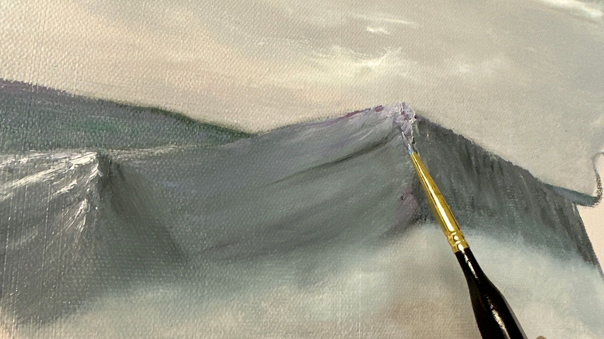 a painting of a mountain and a small paintbrush added purple highlights to the snow-capped peaks