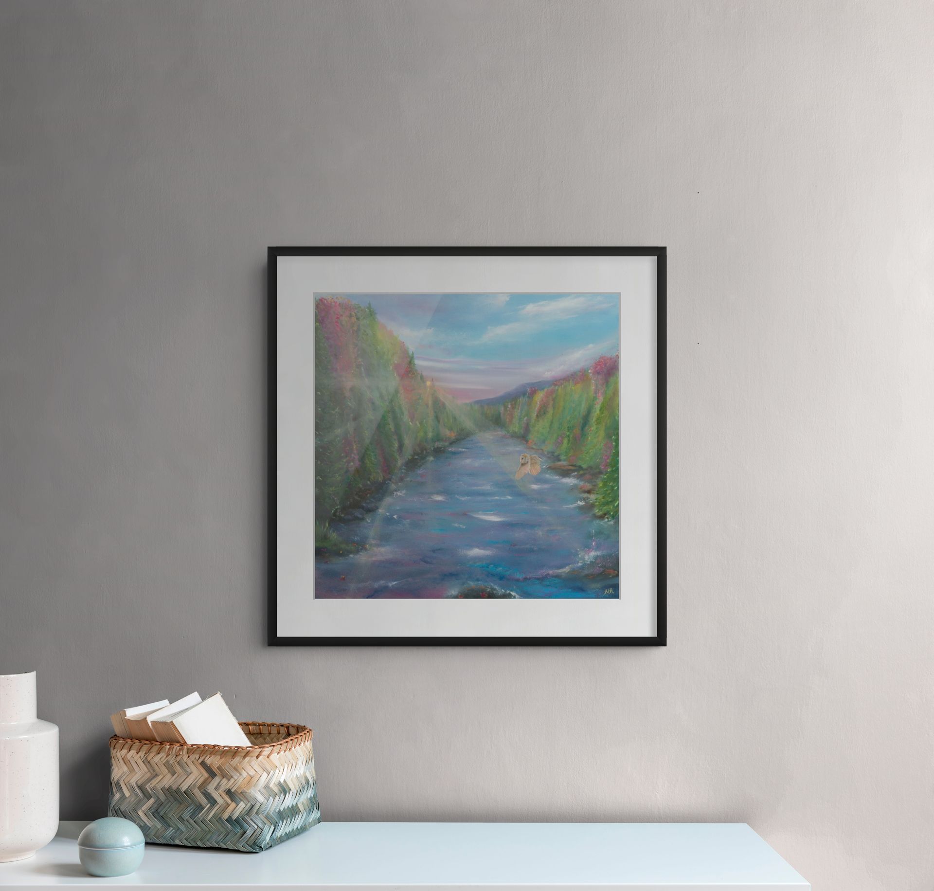 Painting of a white horse emerging from ocean waves on a rocky shore, framed on a gray wall.