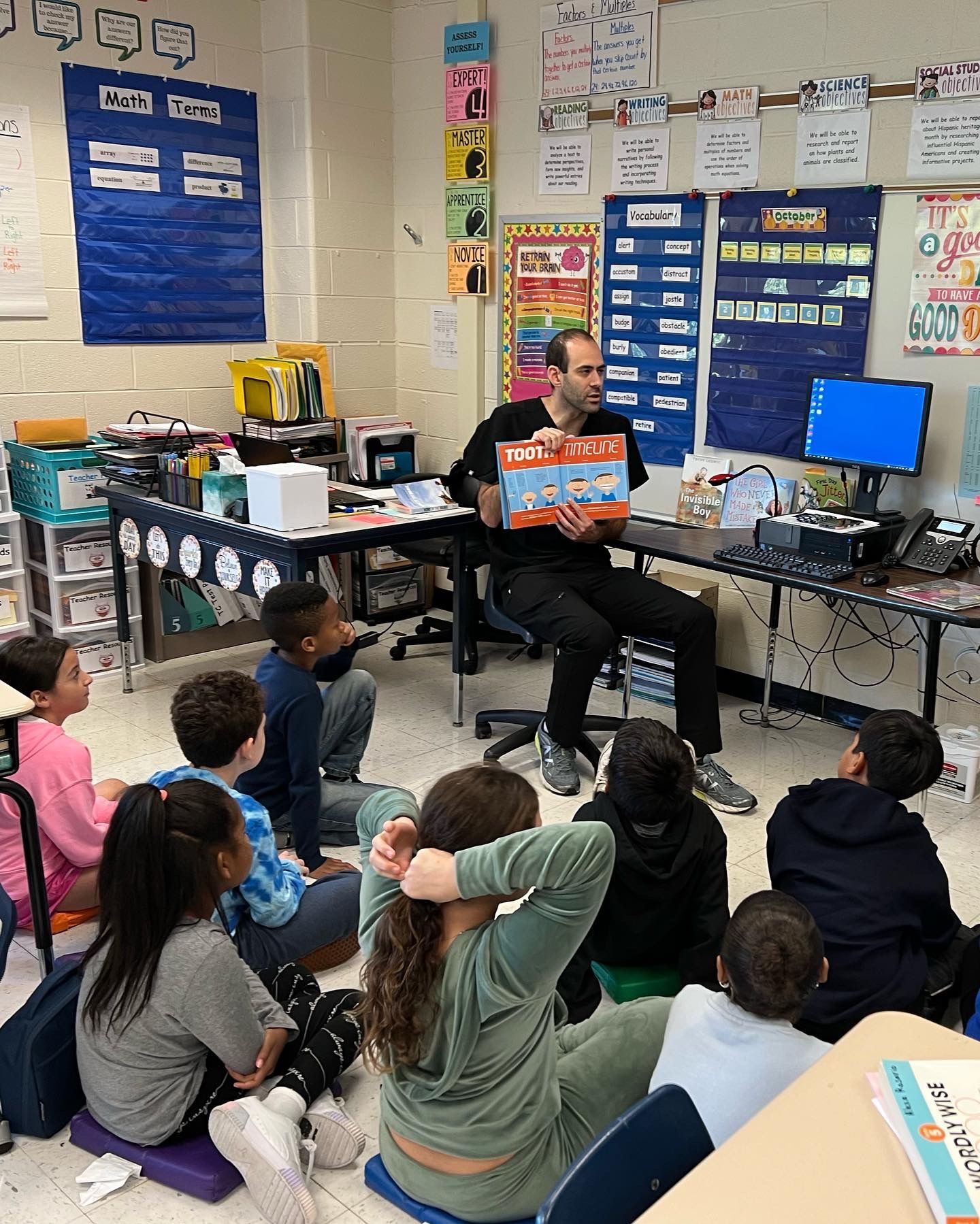 Pediatric Orthodontist | Braces, Clear Aligners, Bite Adjustments | New Rochelle 10804 Dr. Chinitz Reading to Children at School | Orthodontist for Children in New Rochelle 10804 | Fix Bite Issues and Get Braces