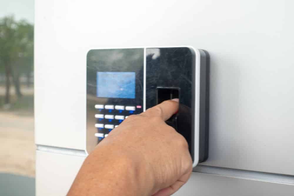 A Person Scanning Their Finger on a Fingerprint Scanner for Access — IRIS CCTV in Glen Innes, NSW