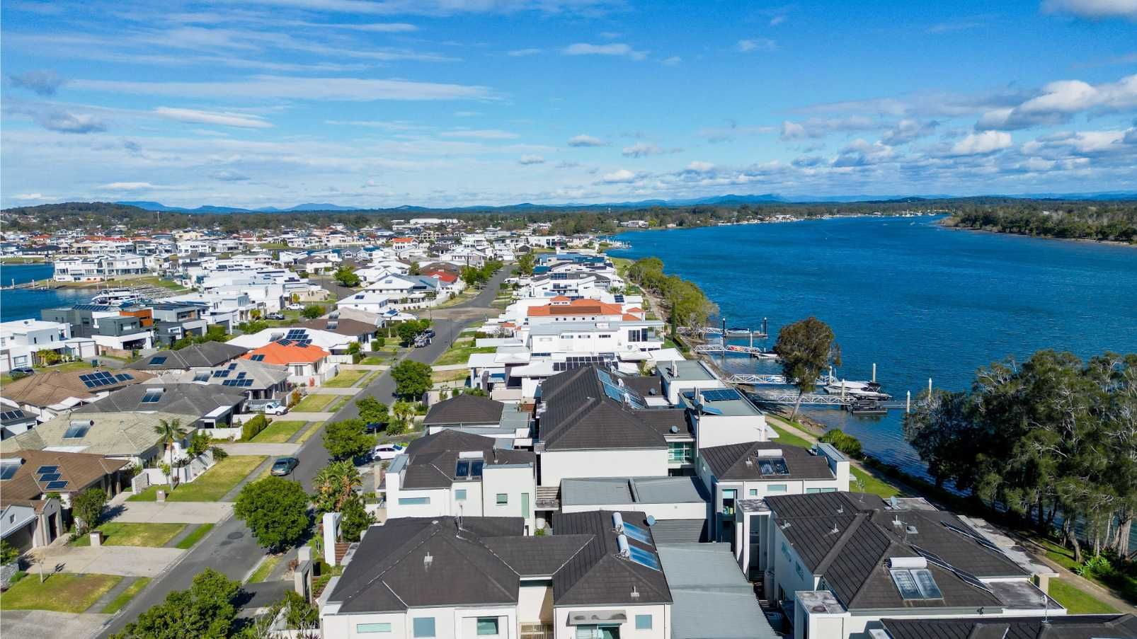 Aerial View of Port Macquarie With Houses, Streets, and a River Under a Blue Sky — IRIS CCTV in Port Macquarie, NSW