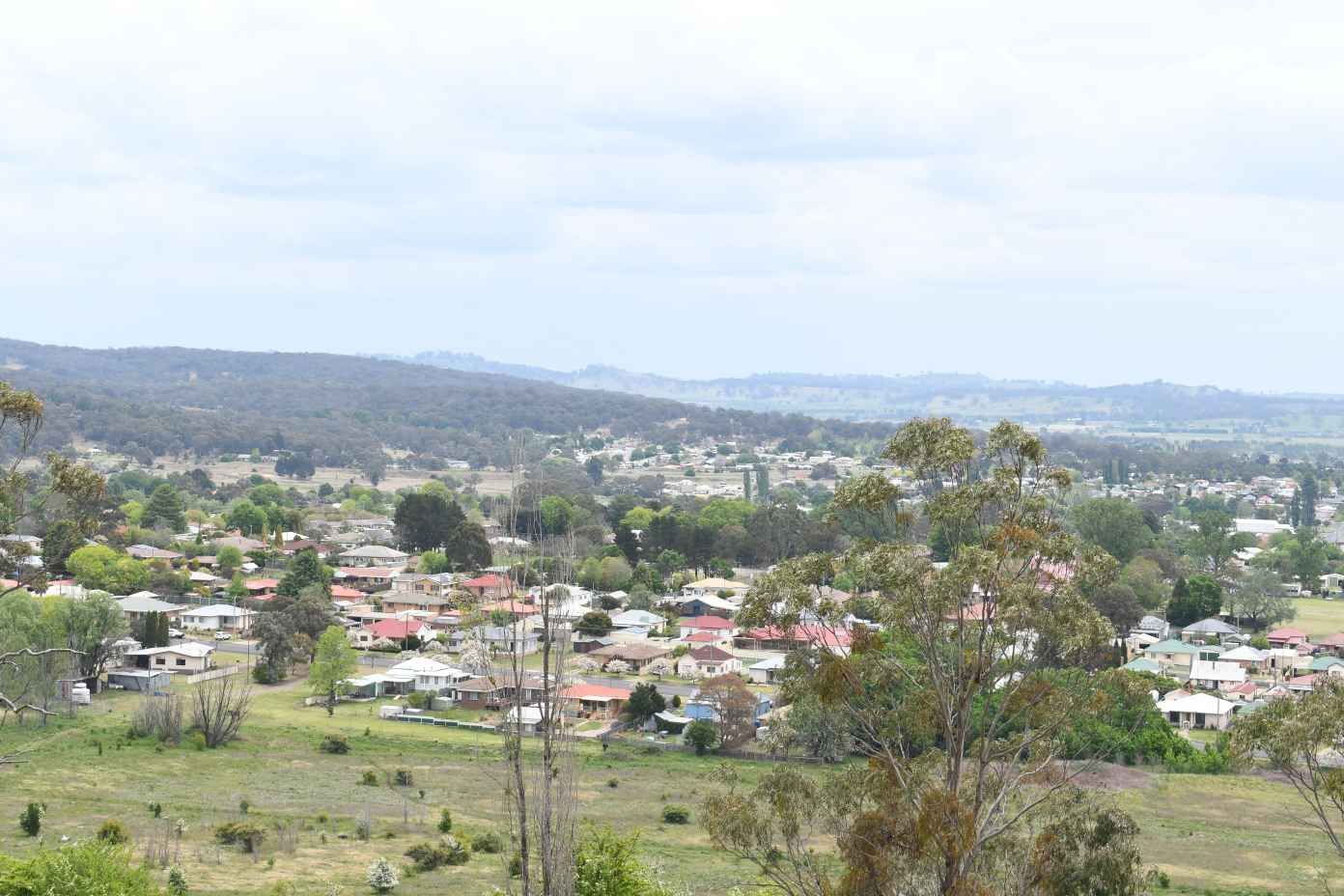 View of Glen Innes Nestled in a Valley, With Houses, Trees, and Hills Under a Cloudy Sky — IRIS CCTV in Glen Innes, NSW