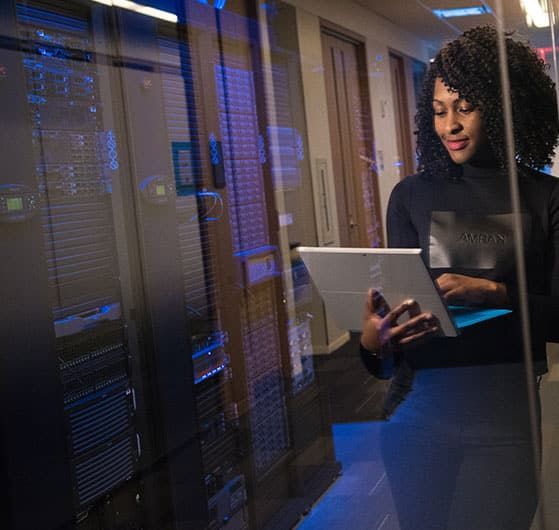 Woman With Tablet in Server Room, Smiling at Data — IRIS CCTV in Ballina, NSW