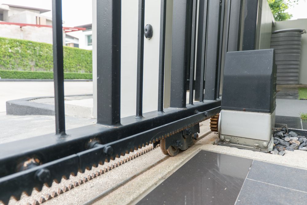 Black Metal Sliding Gate With Cog Wheels — IRIS CCTV in South Grafton, NSW