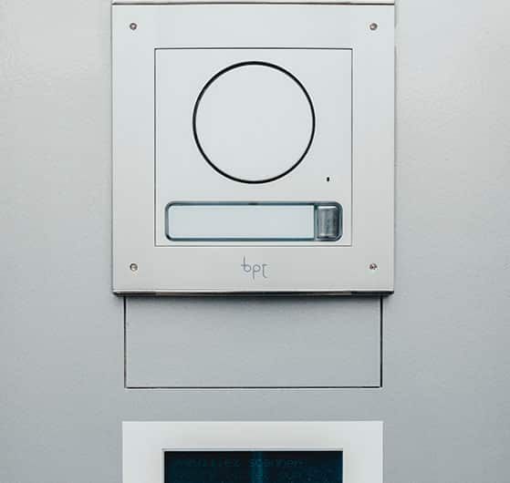 Silver Intercom Device With a Circular Camera and Nameplate on a Light Gray Wall — IRIS CCTV in South Grafton, NSW