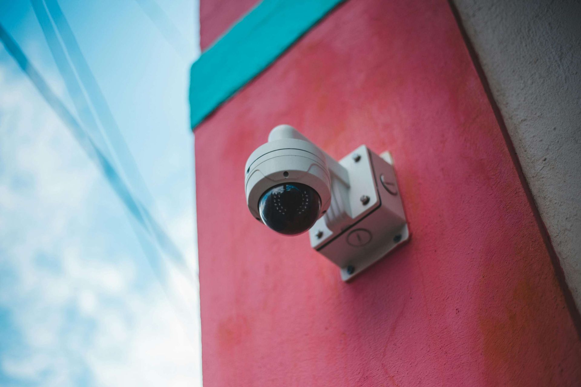 Security Camera Mounted on a Pink and Turquoise Building Exterior — IRIS CCTV in Ballina, NSW