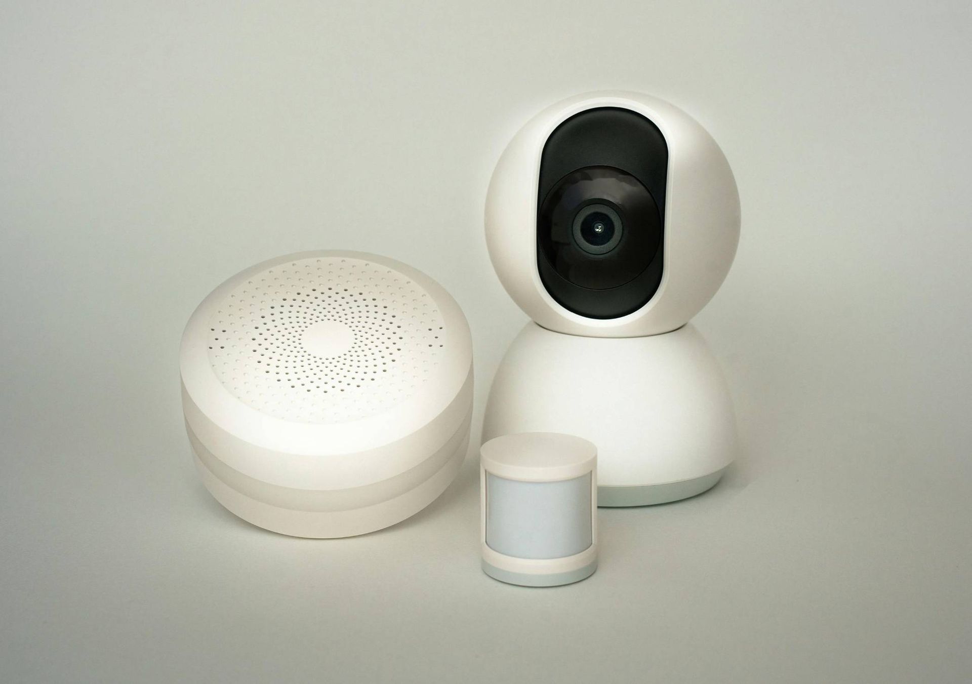 White Security Camera System: Camera, Speaker, and Motion Sensor on a Light Gray Surface — IRIS CCTV in South Grafton, NSW