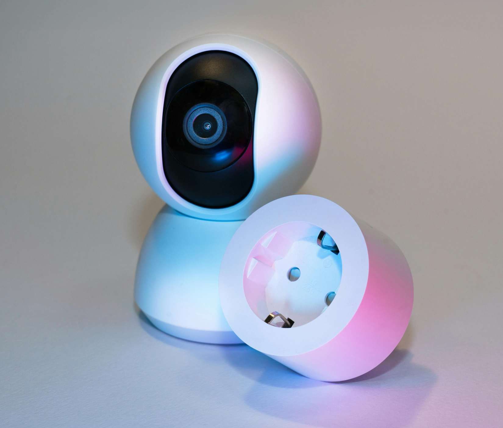 White Security Camera With a Detached, Open Base, Lit With Pink and Blue Light — IRIS CCTV in Ballina, NSW