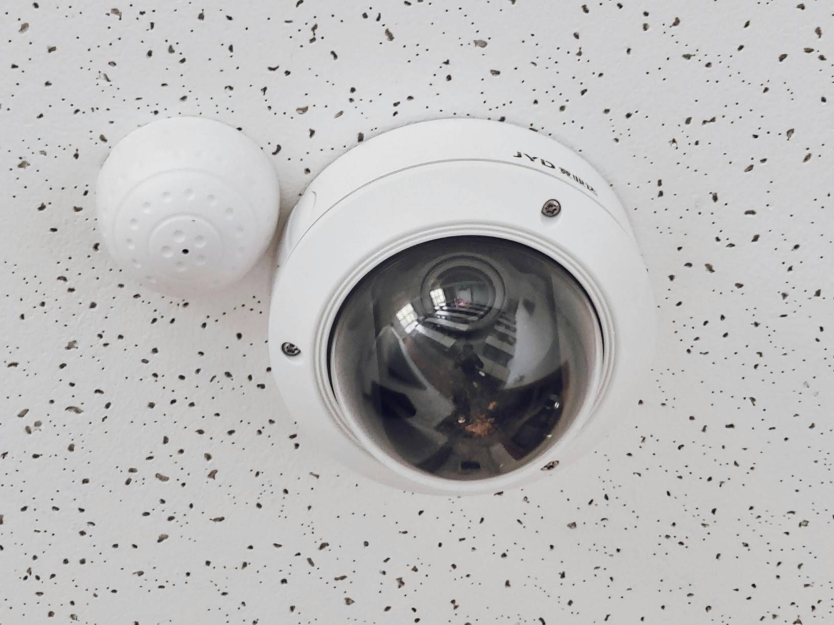 White Security Camera and Sensor Mounted on a Speckled Ceiling — IRIS CCTV in South Grafton, NSW