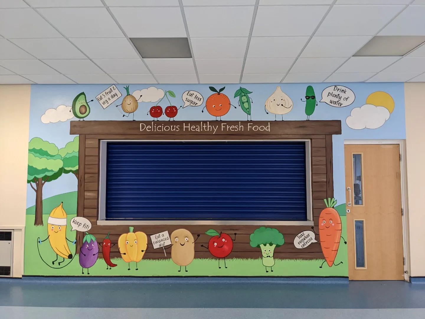 An ordinary primary school dinner hatch that custom murals has transformed into a mural of a food hut fruit & veg people