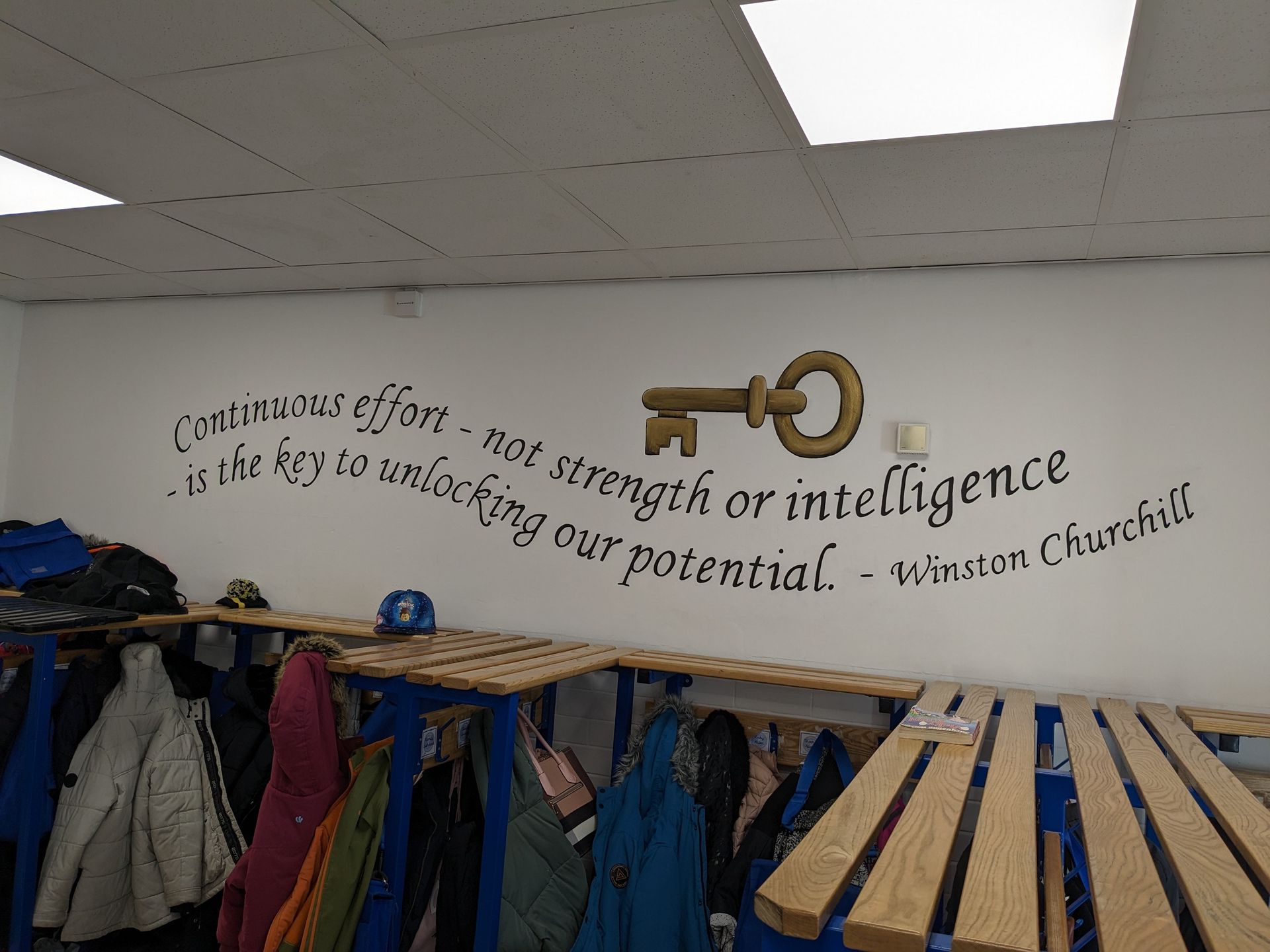 KEY  WITH THE QUOTE CONTINUOUS EFFORD NOT STRENGTH OR INTELLIGENCE IS THE KEY TO UNLOCK  MURAL IN PRIMARY SCHOOL CLOAKROOM