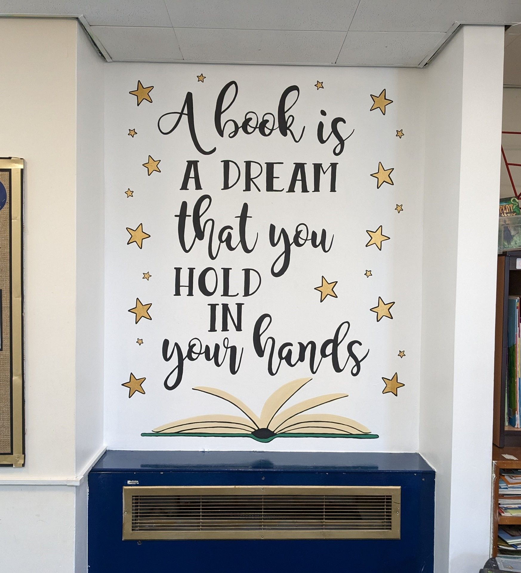 A book is a dream that you hold in your hands primary school murals village education 
