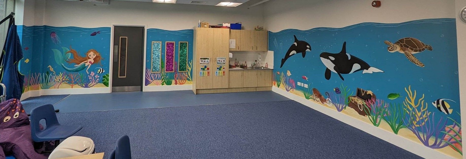 A MURAL OF UNDERWATER SCENE WITH WHALES  THE ROOM IS FOR SEN PUPILS AT A PRIMARY SCHOOL