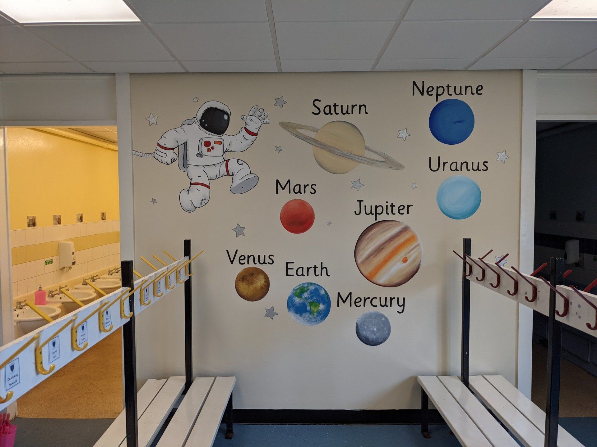 space mural in primary school nursery cloakroom
