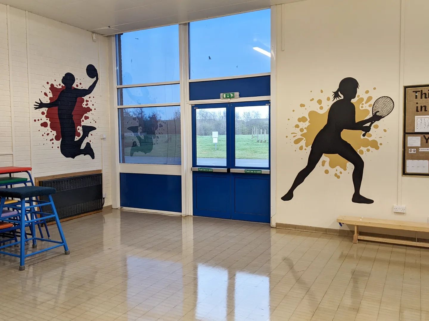 sports people silhouettes with a splash of colour behind them in a primary school hall hand painted murals  tennis