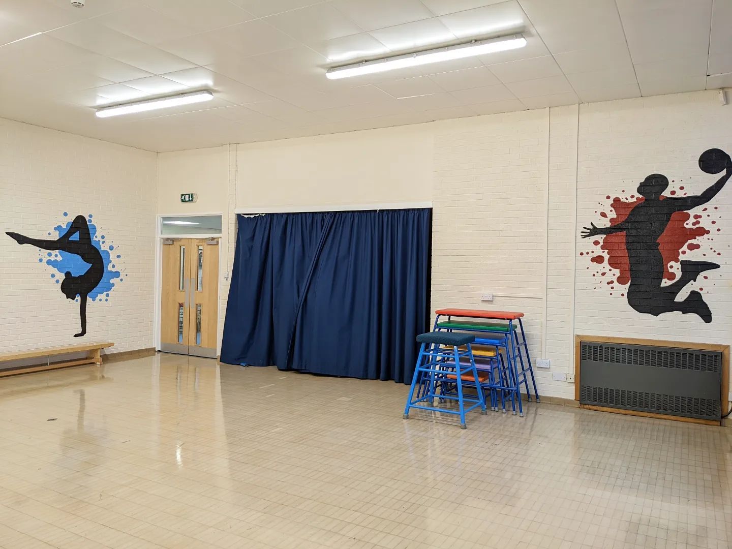 sports silhouettes with a splash of colour behind them in a primary school hall hand painted murals  basket ball dance
