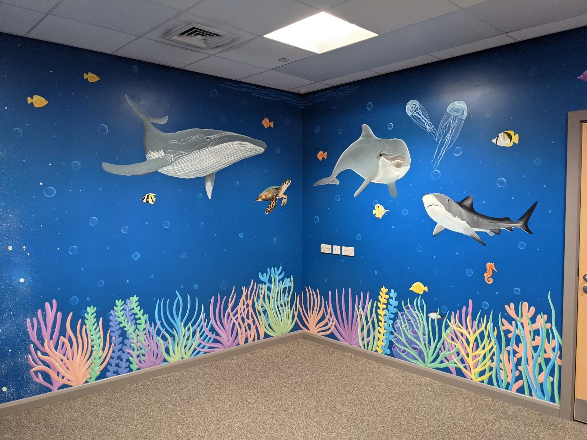 under water  scene hand painted mural 
 for a sensory room in a primary school 
