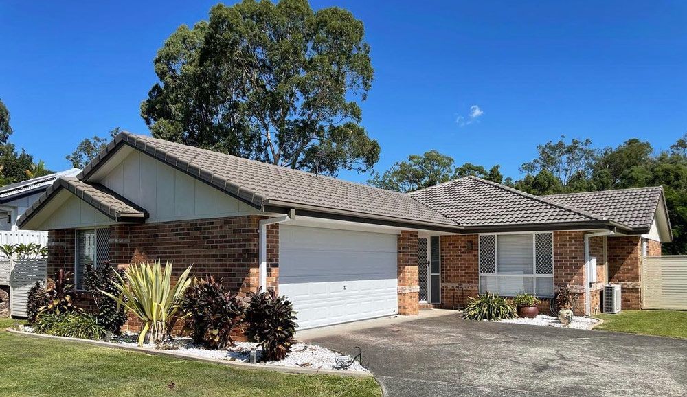 Owners of Johnston & Johnston Restoration holding paint buckets — Roofer in Southport QLD