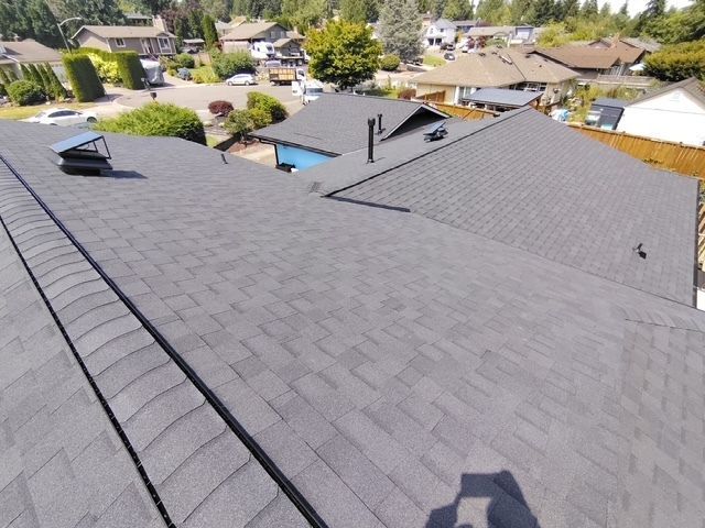 Aerial view of gray shingled rooftops in a suburban neighborhood