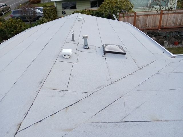 White metal roof with vents and skylight seen from above