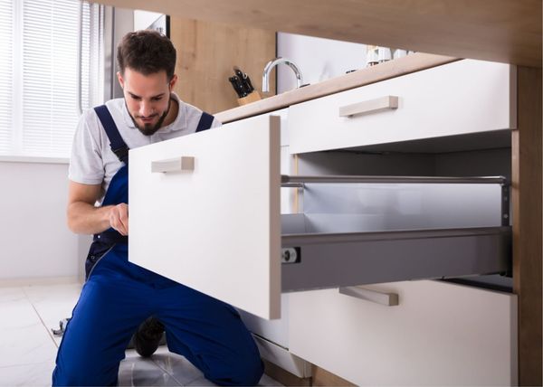 Saskatoon Handyman services installing a cabinet