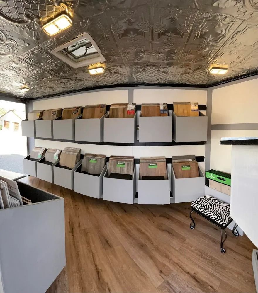 A room with wall-mounted storage bins filled with cardboard files and a wood floor