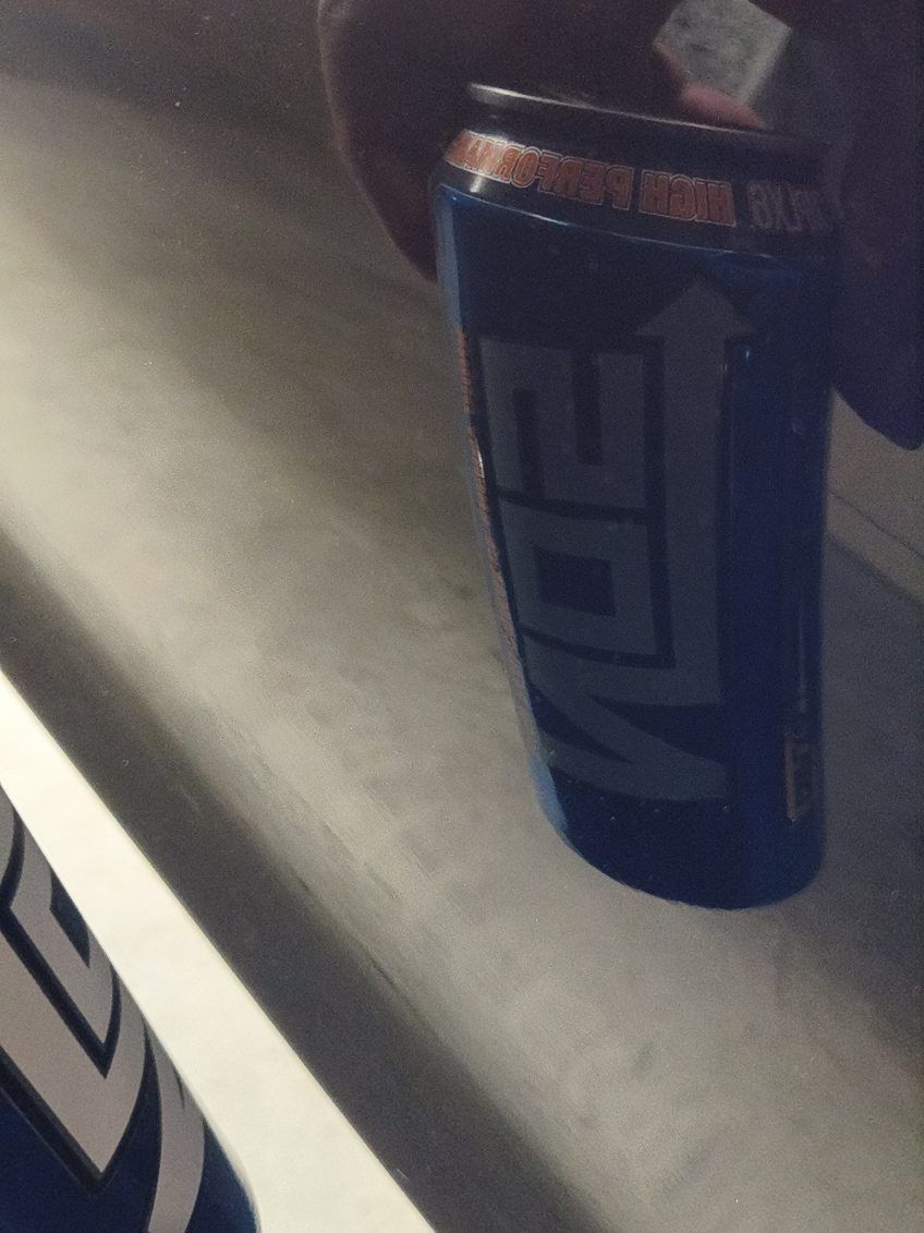 Blue energy drink can on a countertop, with a second can partially visible at left.