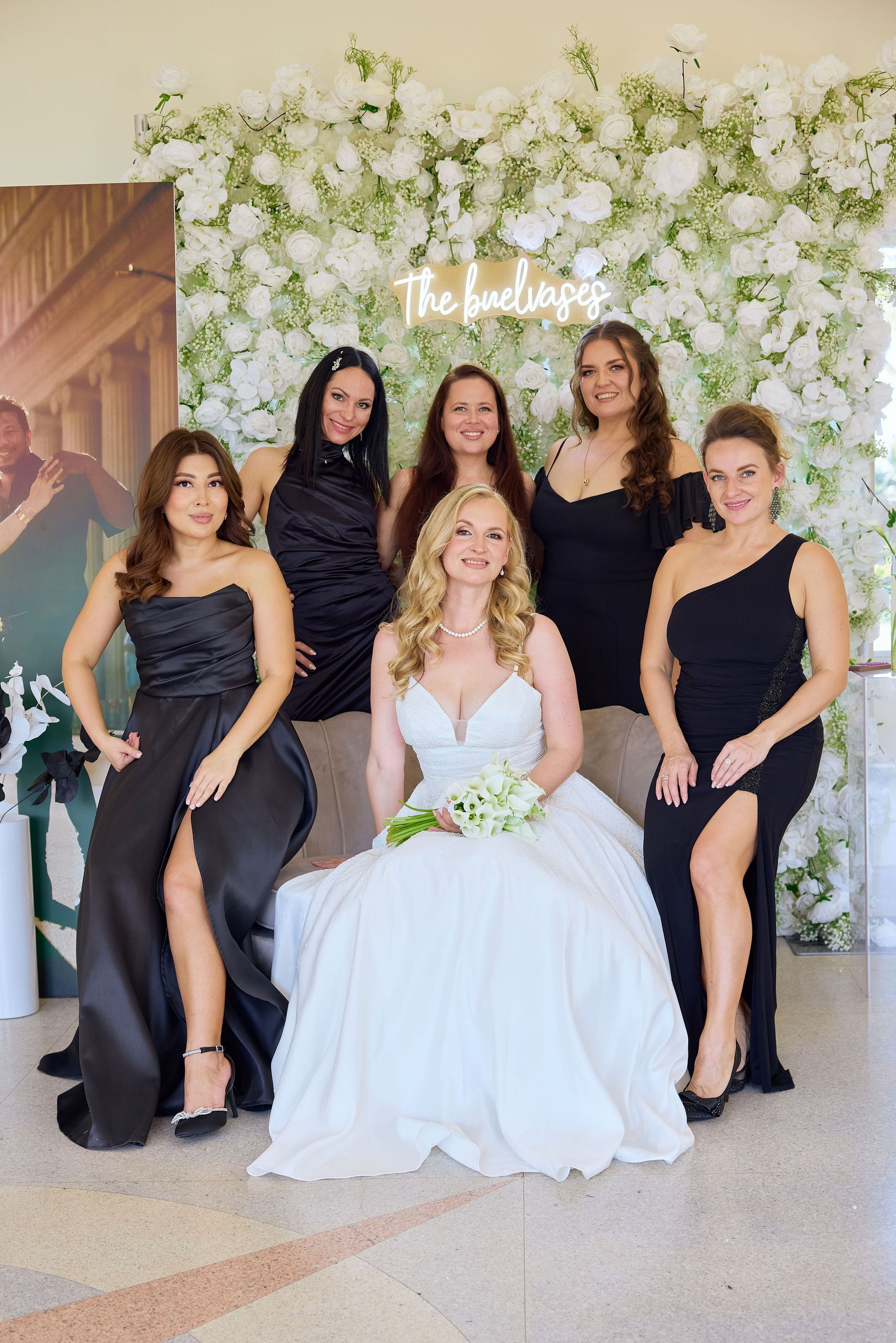 A bride and her bridesmaids are posing for a picture.