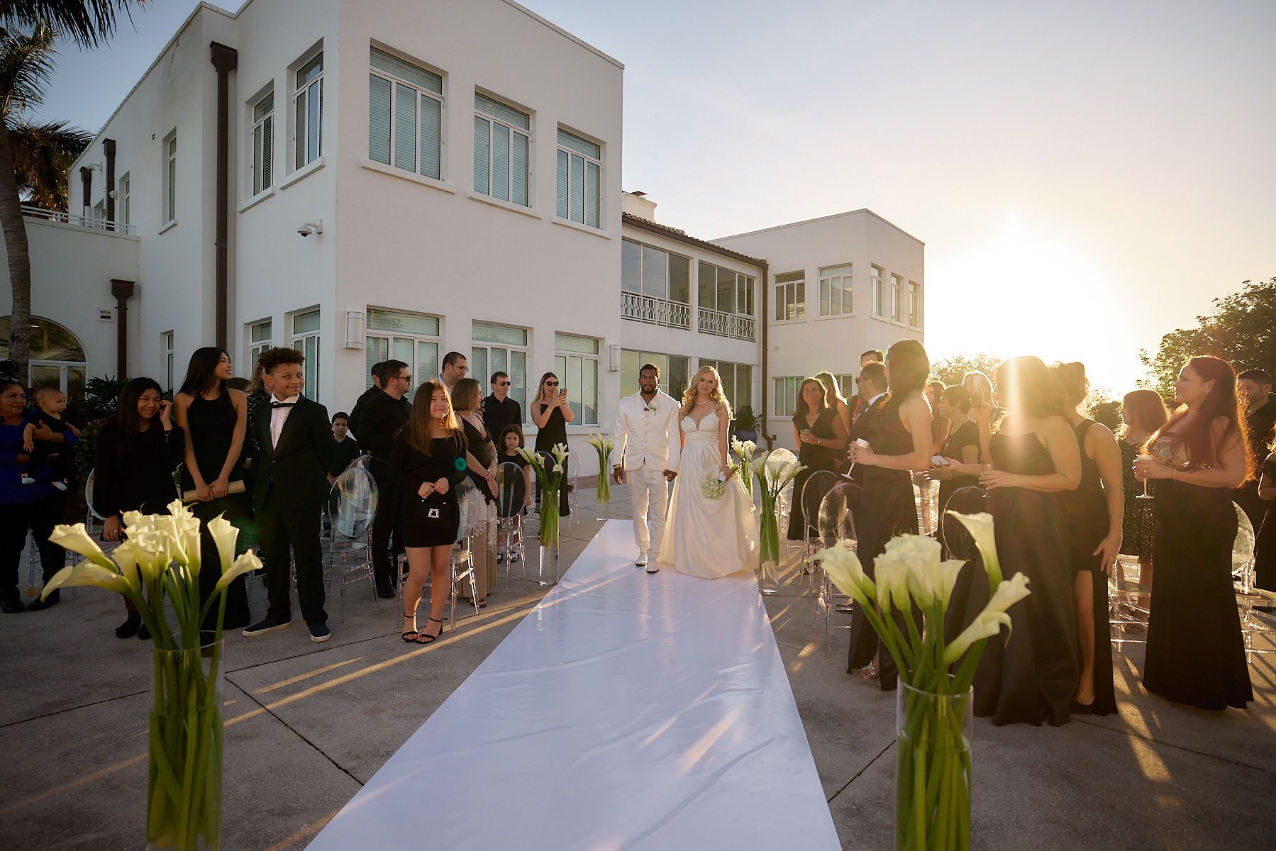 A bride and groom are walking down the aisle at their wedding