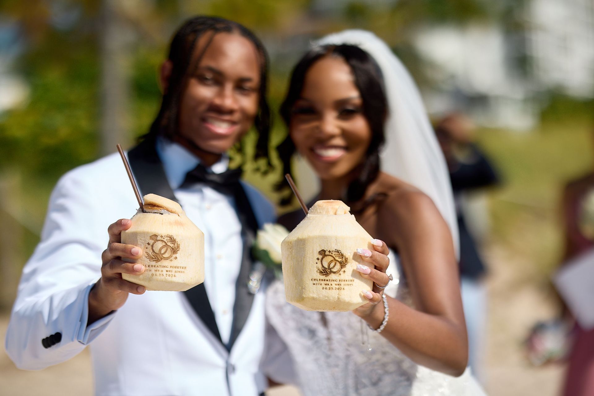 bride and groom holding coconuts at their beach wedding in fort lauderdale