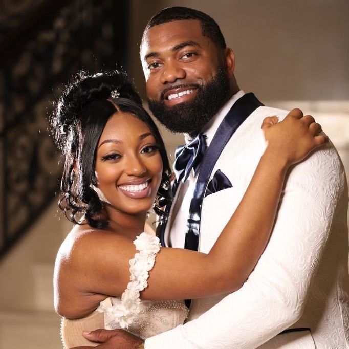 A bride and groom are posing for a picture together