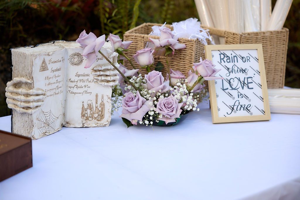 Wedding reception table with flowers, decorations, and a sign that says,