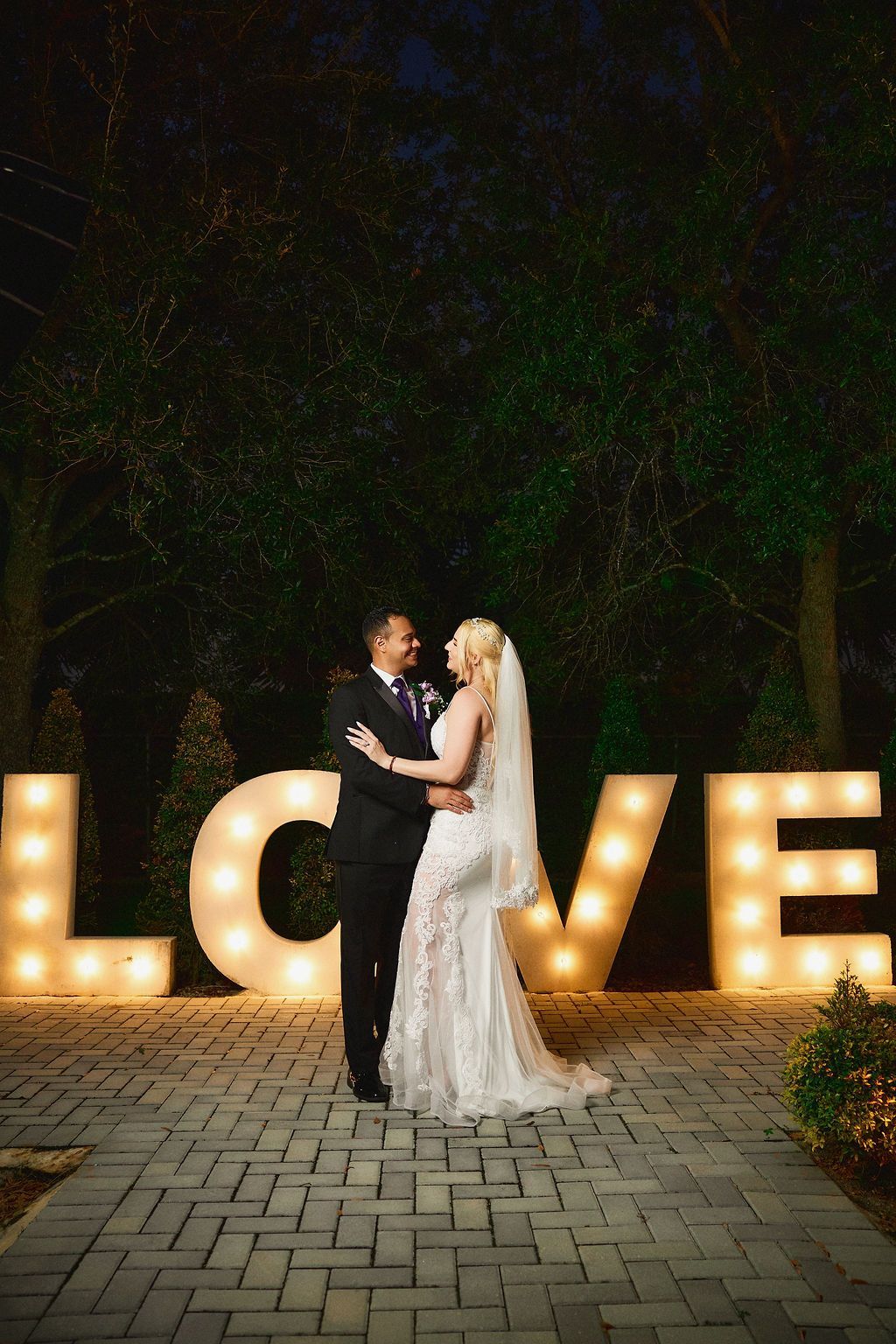 Couple embracing by lit