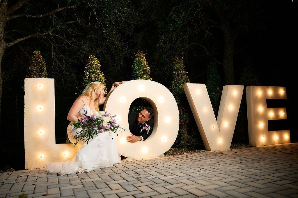 Bride and groom pose with illuminated
