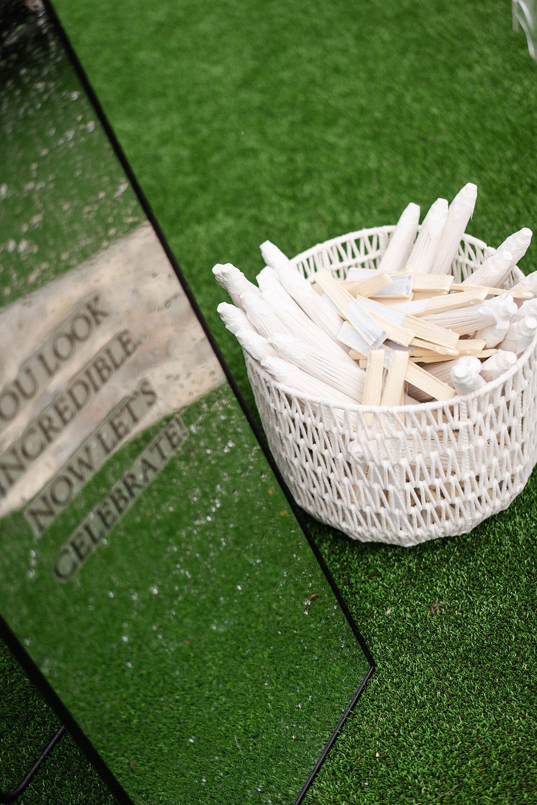 Basket of white sticks and mirror with text 