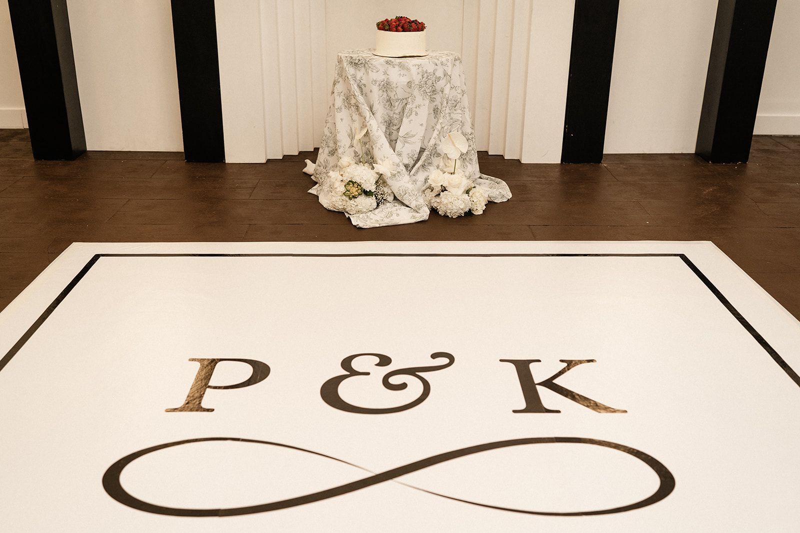 White dance floor with gold initials 