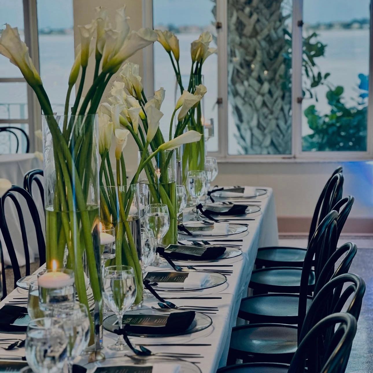 A long table with flowers and candles on it- wedding reception inside the Mansion At Tuckahoe
